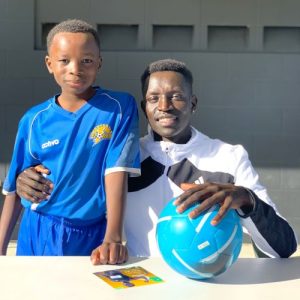 Peter Bol - Pushing Barriers ambassador - with Salehe - a young boy from a refugee background who plays sport in Brisbane.